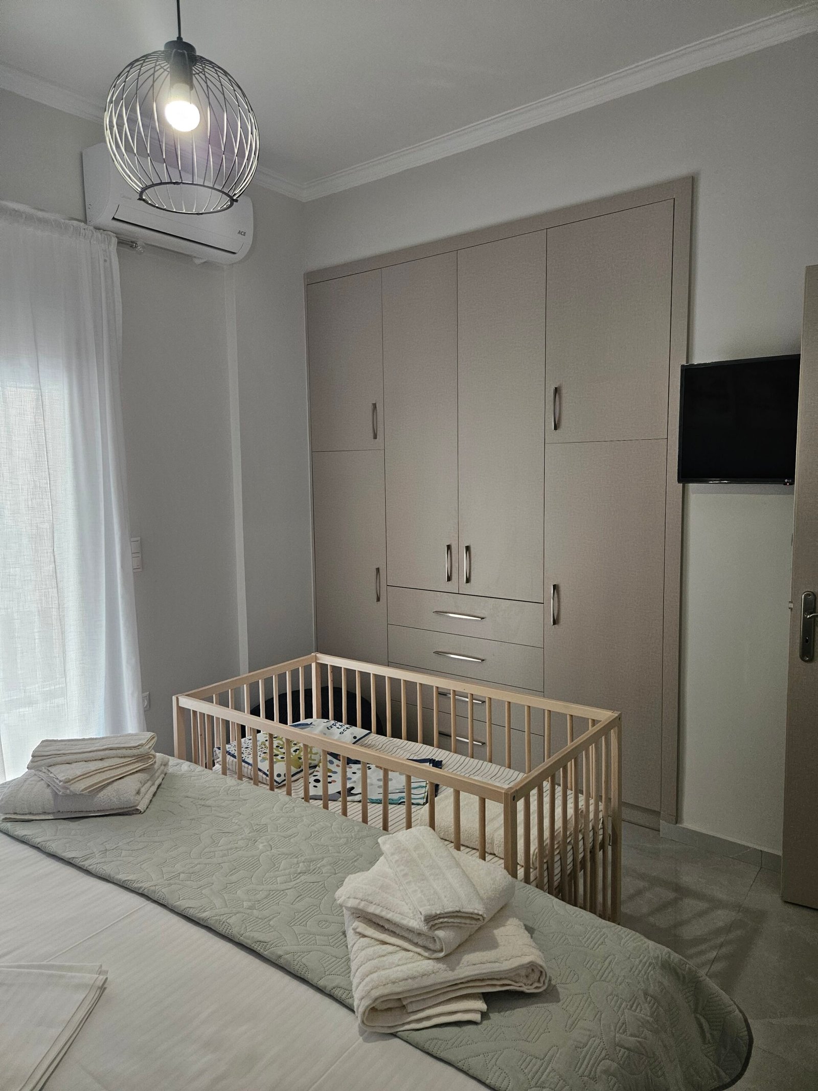 Master bedroom with baby cot available upon request, wardrobe and television